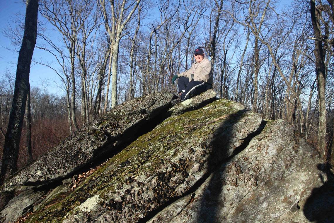 “Spooky” Mike Schwartz sits atop a boulder on Burley Hill, near the high point of Tolland County, Connecticut, in 2014. Courtesy of Michael Schwartz