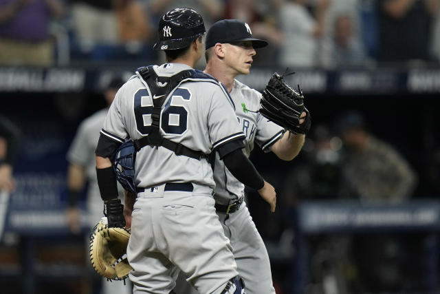 New York Yankees catcher Kyle Higashioka (66) and relief pitcher Ian Hamilton celebrate after closing out the Tampa Bay Rays during the ninth inning of a baseball game Saturday, May 6, 2023, in St. Petersburg, Fla. (AP Photo/Chris O'Meara)