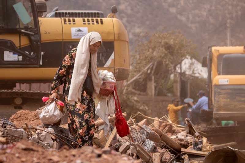 A woman removes salvaged items from a collapsed building in Ouirgane, Morocco, on Tuesday. A magnitude 6.8 earthquake struck on Friday, killing and injuring thousands. Photo by Jerome Favre/EPA-EFE