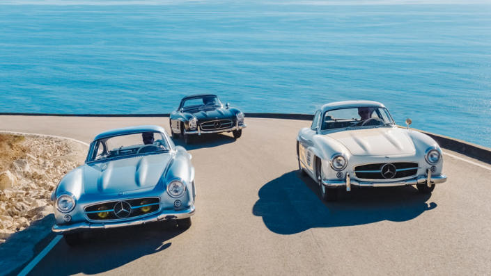 On a scenic Malibu road, examples of the 300 SL &#x00201c;Gullwing&#x00201d; coupe from 1954 (left) and 1955 (right) are followed by a 300 SL Roadster circa 1963. - Credit: Daniel Malikyar