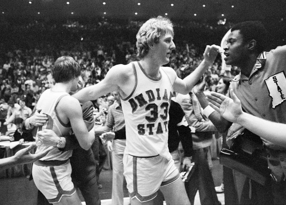 Indiana State star Larry Bird makes his way through the crowd of players and fans getting congratulations after his team defeated Arkansas, 73-71, to win the NCAA Midwest Regional tourney crown in Cincinnati, March 17, 1979.