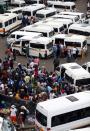 Passengers are seen at taxi rank as residents of a number of African cities where the coronavirus is spreading are heading to the countryside to try to escape from the disease, in Johannesburg