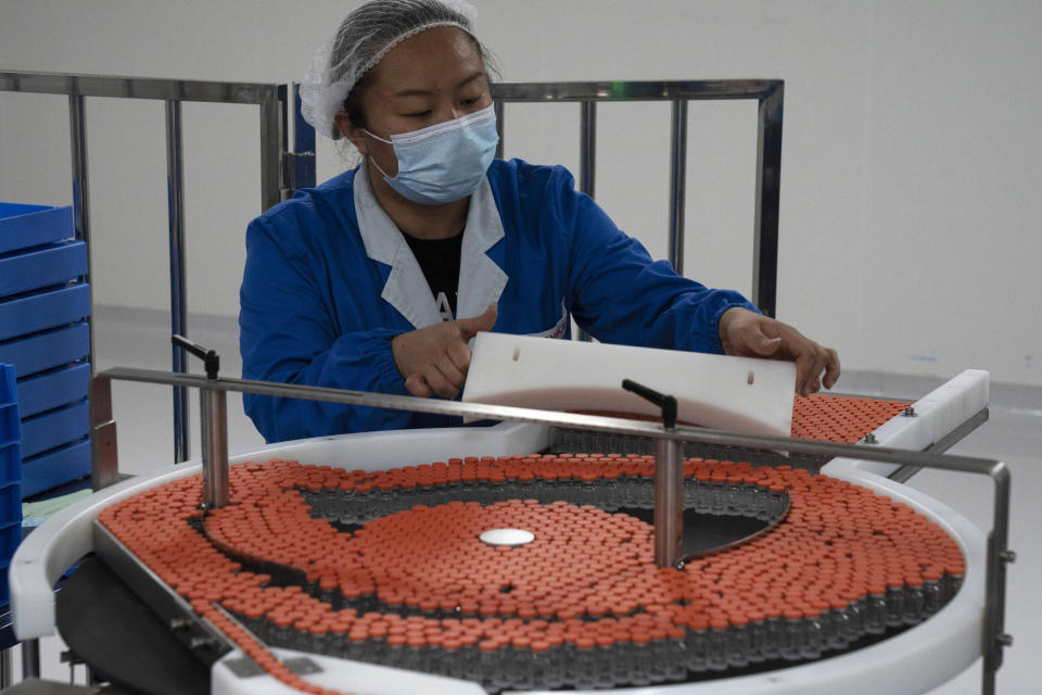 A worker loads vials to be used in the production line for a vaccine for COVID-19 at Chinese company Sinovac at its factory in Beijing on Thursday, Sept. 24, 2020. With rich countries snapping up supplies of COVID-19 vaccines, some parts of the world may have to rely on Chinese-developed shots to conquer the outbreak. The question: Will they work? (AP Photo/Ng Han Guan)