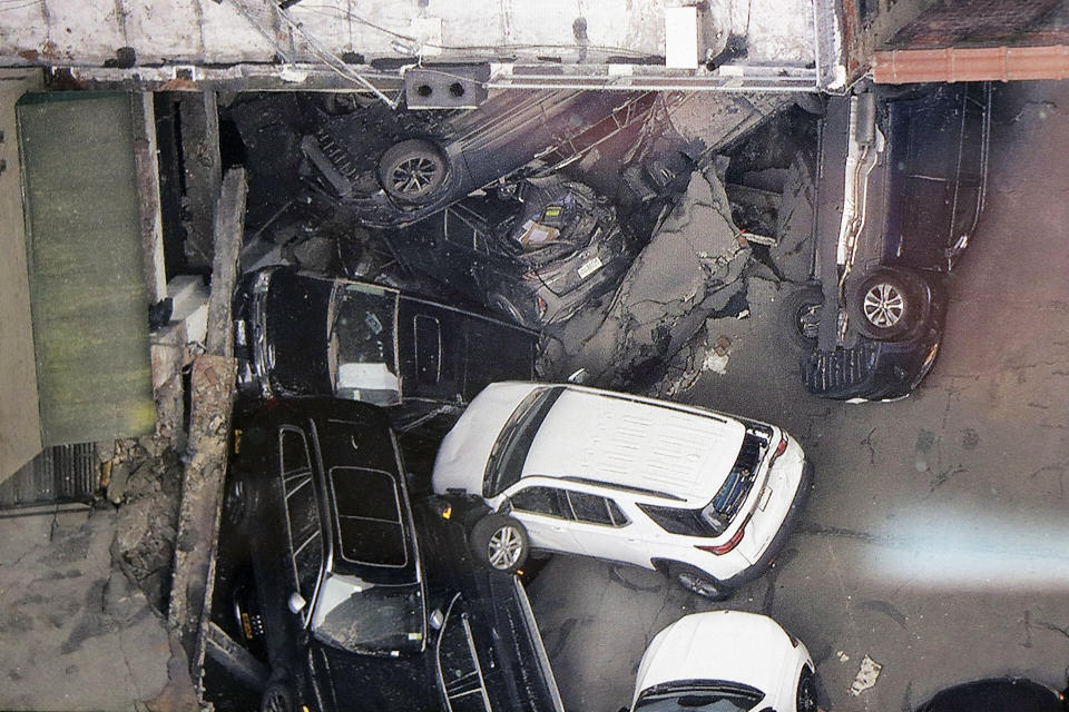 FILE — Cars are seen at the partial collapse of a parking garage in the Financial District of New York, April 19, 2023, in New York. After the deadly collapse of a parking structure in lower Manhattan, New York City building officials swept through dozens of parking garages and ordered four of them to immediately shutter because of structural issues that "deteriorated to the point where they were now posing an immediate threat to public safety." (Tom Kaminski/WCBS 880 News via AP)