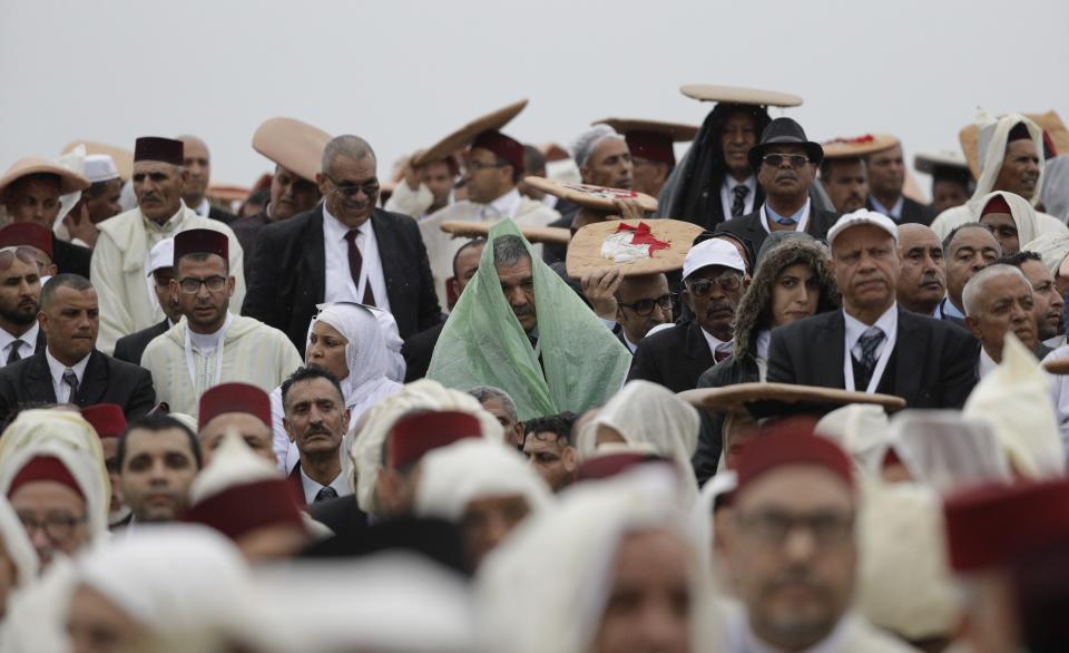 People listen as Pope Francis delivers his speech at the Hassan Mosque plaza in Rabat, Morocco, Saturday, March 30, 2019. Francis's weekend trip to Morocco aims to highlight the North African nation's tradition of Christian-Muslim ties while also letting him show solidarity with migrants at Europe's door and tend to a tiny Catholic flock on the peripheries. (AP Photo/Gregorio Borgia)
