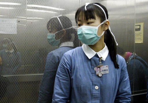 This file photo shows a nurse in a lift of the Queen Mary hospital in Hong Kong. Hong Kong is particularly nervous about infectious diseases following the 2003 SARS outbreak, which killed 300 people in the city and a further 500 worldwide