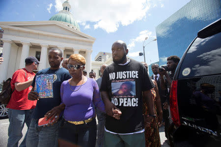 FILE PHOTO: Michael Brown Sr. (R) and Lesley McSpadden, the parents of dead teenager Michael Brown, leave after a news conference in St. Louis, Missouri, U.S., August 12, 2014. REUTERS/Mario Anzuoni/File Photo