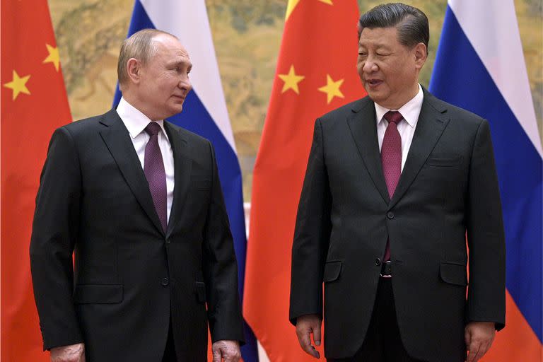 FILE - Chinese President Xi Jinping, right, and Russian President Vladimir Putin talk to each other during their meeting in Beijing, Feb. 4, 2022. China is the only friend that might help Russia blunt the impact of economic sanctions over its invasion of Ukraine, but President Xi Jinping government is giving no sign it might be willing to risk its own access to U.S. and European markets by doing too much. (Alexei Druzhinin, Sputnik, Kremlin Pool Photo via AP, Fil