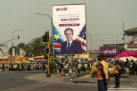 A poster of Secretary of State Antony Blinken is visible as his motorcade moves through Kinshasa, Congo, Tuesday, Aug. 9, 2022. Blinken is on a ten day trip to Cambodia, Philippines, South Africa, Congo, and Rwanda. (AP Photo/Andrew Harnik, Pool)