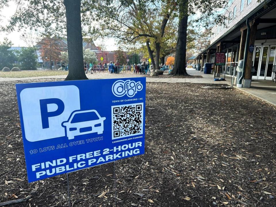 Carrboro town staff put up these signs in 2023 to direct drivers to free public parking lots after dozens of cars were towed from private downtown lots, including the parking lot at Weaver Street Market. The town is now considering a fee for parking in public lots.