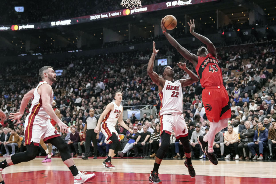 Toronto Raptors' Pascal Siakam, right, shoots on Miami Heat's Jimmy Butler during the first half of an NBA basketball game, Wednesday, Dec. 6, 2023 in Toronto. (Chris Young/The Canadian Press via AP)