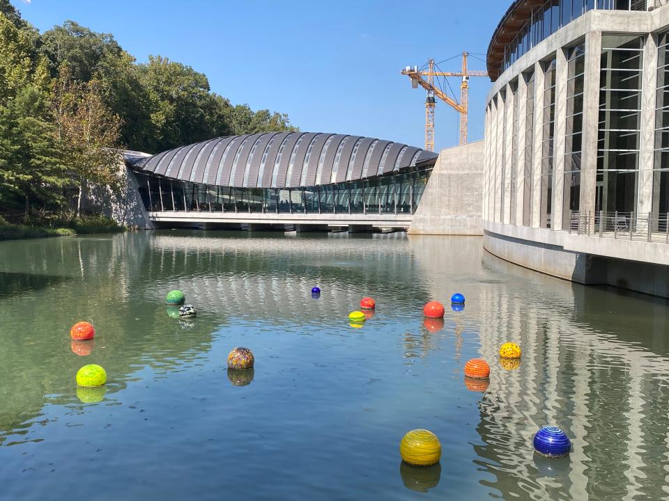 Architect Moshe Safdie’s design concept for the Crystal Bridges Museum of American Art was to meld the structures with the hilly Arkansas Ozark landscape. The glasswork of artist Dale Chihuly bobs in one of two ponds on which the museum was built.
