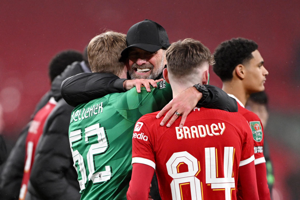 Liverpool manager Jurgen Klopp (centre) hugs goalkeeper Caoimhin Kelleher and Conor Bradley after their Carabao Cup final win over Chelsea.