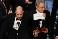 "La La Land" producer Jordan Horowitz holds up the card reading Best Film 'Moonlight" next to US actor Warren Beatty who earlier mistakenly read out "La La Land" at the 89th Oscars in Hollywood on February 26, 2017