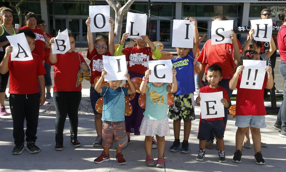 <p>Kids hold up signs during an immigration family separation protest in front of the Sandra Day O’Connor U.S. District Court building, Monday, June 18, 2018, in Phoenix, Ariz. An unapologetic President Trump defended his administration’s border-protection policies Monday in the face of rising national outrage over the forced separation of migrant children from their parents. (Photo: Ross D. Franklin/AP) </p>