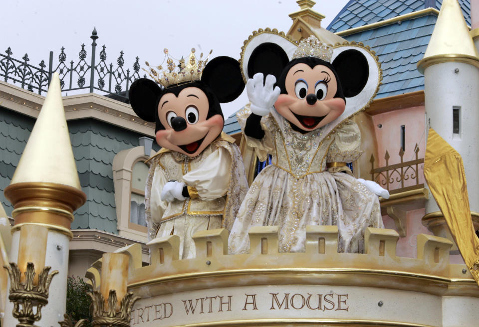 Disney characters Mickey and Minnie Mouse wave during a parade along Main Street at Disneyland in Anaheim, Calif., seen in this May 4, 2005, file photo, at the start of the "Happiest Homecoming On Earth," an 18-month commemoration of the 50th anniversary of the first Disney theme park. Disney announced a new marketing campaign Wednesday, June 7, 2006, for Disney theme parks around the world called a "Year of a Million Dreams." The campaign will launch in October to replace the 18 month Disneyland 50th anniversary promotion. (AP Photo/Damian Dovarganes)