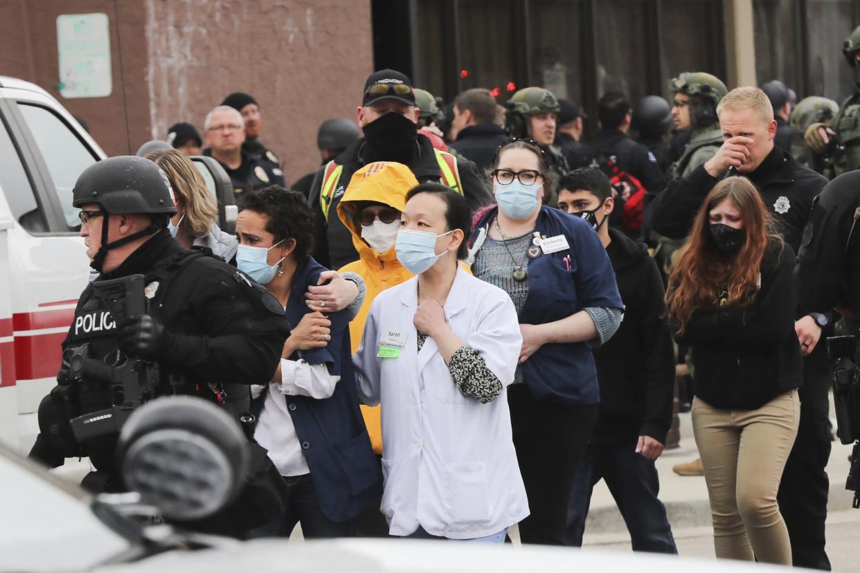 People are led out of a King Soopers grocery store after a shooting in the store, Monday, March 22, 2021, in Boulder, Colo.