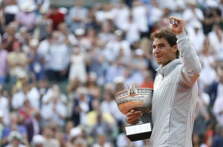 Rafael Nadal of Spain reacts as he attends the trophy ceremony after defeating Novak Djokovic of Serbia during their men's singles final match to win the French Open Tennis tournament at the Roland Garros stadium in Paris June 8, 2014. REUTERS/Vincent Kessler