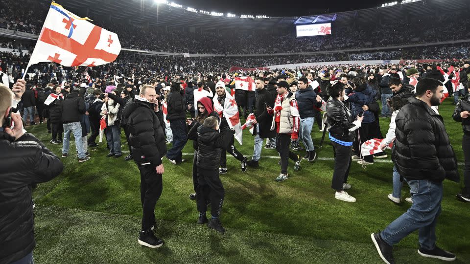 Georgia's fans celebrate their team reaching Euro 2024 at the Boris Paichadze National Stadium in Tbilisi. - Tamuna Kulumbegashvili/AP