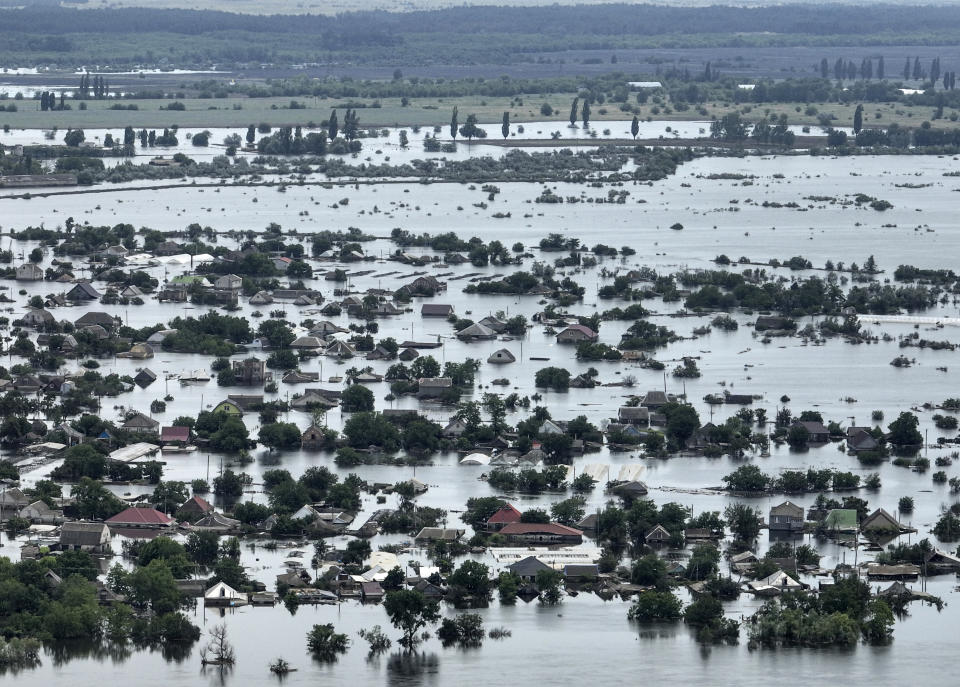 Houses are seen underwater in the flooded town of Oleshky, Ukraine, Saturday, June 10, 2023. The destruction of the Kakhovka Dam in southern Ukraine is swiftly evolving into long-term environmental catastrophe. It affects drinking water, food supplies and ecosystems reaching into the Black Sea. (AP Photo)