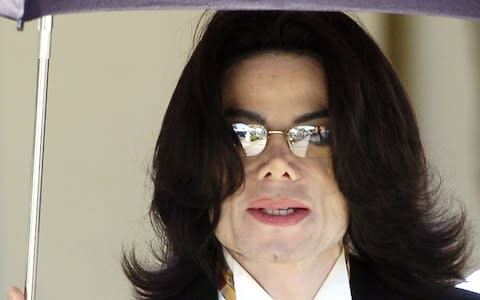 Michael Jackson leaving the Santa Barbara county courthouse in 2005 after a former employee of his Neverland ranch took the stand to dispute the testimony of a maid who claimed the pop star inappropriately touched actor Macaulay Culkin and other boys - Credit: Phil Klein/Reuters
