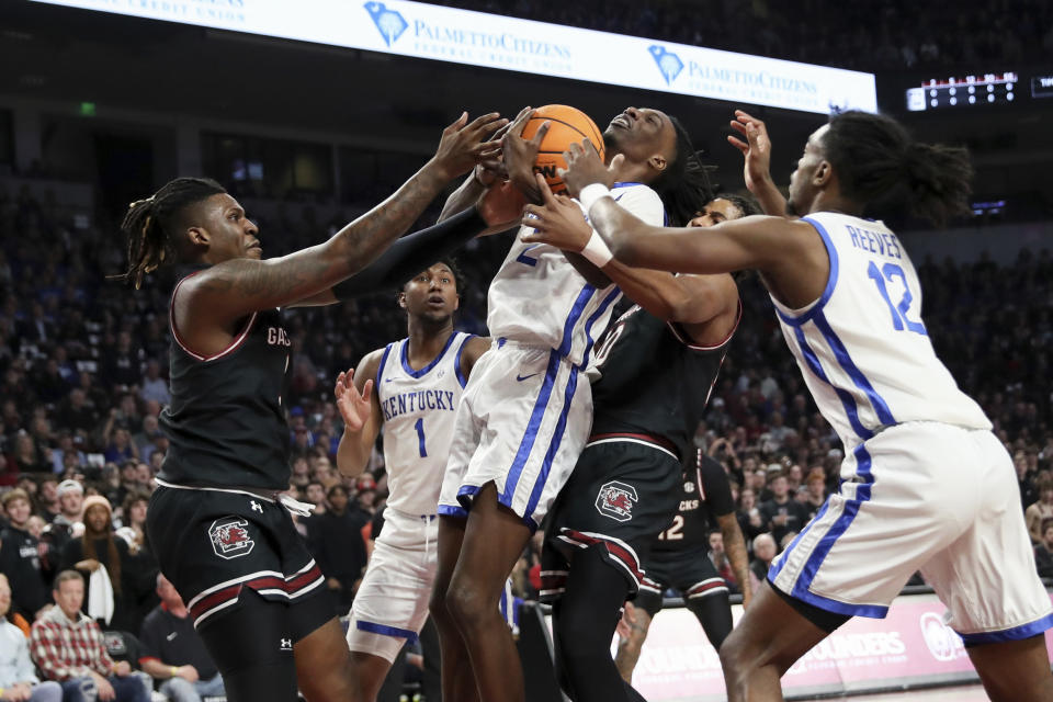 Kentucky forward Aaron Bradshaw (2) grabs a defensive rebound from South Carolina forward B.J. Mack, left, and forward Collin Murray-Boyles (30) during the first half of an NCAA college basketball game Tuesday, Jan. 23, 2024, in Columbia, S.C. (AP Photo/Artie Walker Jr.)