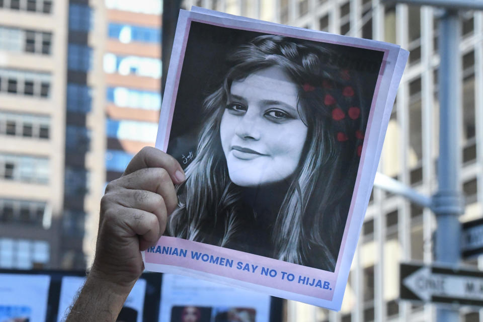 A protester holds up a photo of Mahsa Amini at a demonstration against visiting Iranian President Ebrahim Raisi, outside the United Nations, Sept. 21, 2022, in New York City.  / Credit: STEPHANIE KEITH/Getty