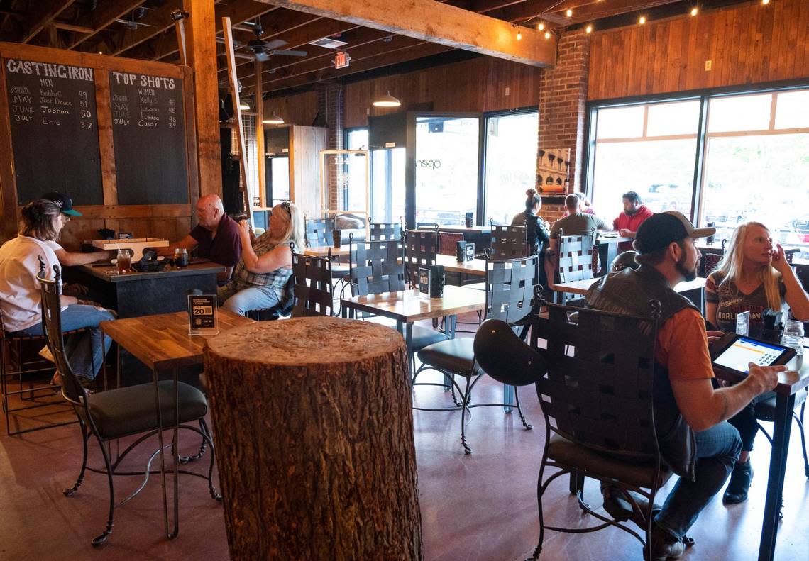 Customers dine in while others throw axes at Casting Iron in Enumclaw, Wash. on Friday, July 8, 2022.