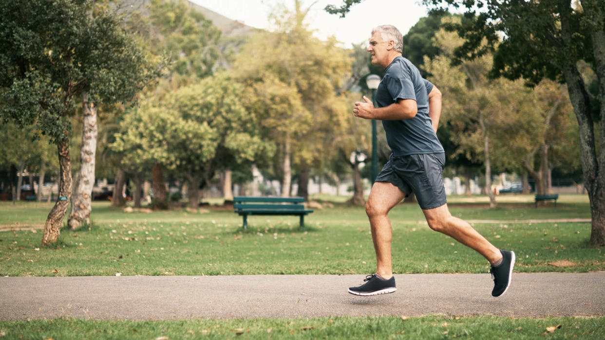 Shot of a senior man out for a run in the park.