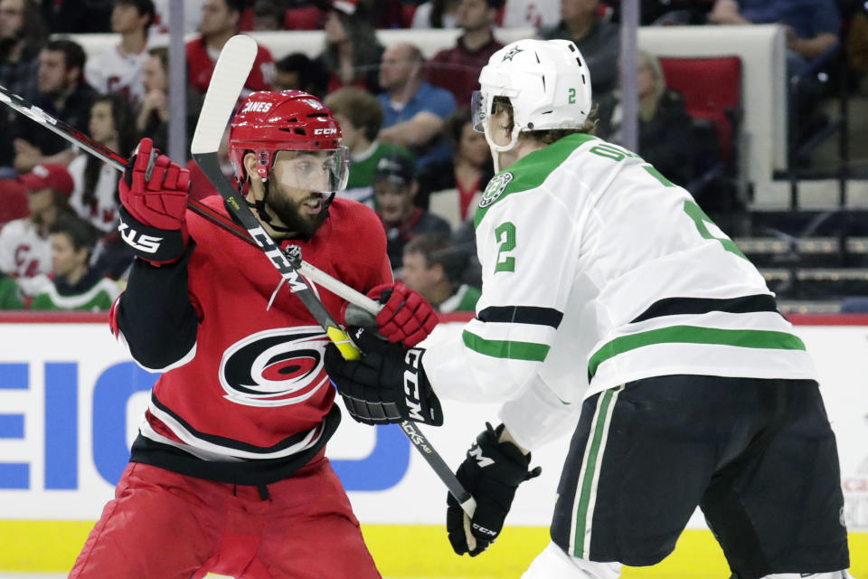 Carolina Hurricanes' Vincent Trocheck (16) battles for position against Dallas Stars' Jamie Oleksiak (2) during the second period of an NHL hockey game in Raleigh, N.C., on Tuesday, Feb. 25, 2020. (AP Photo/Chris Seward)