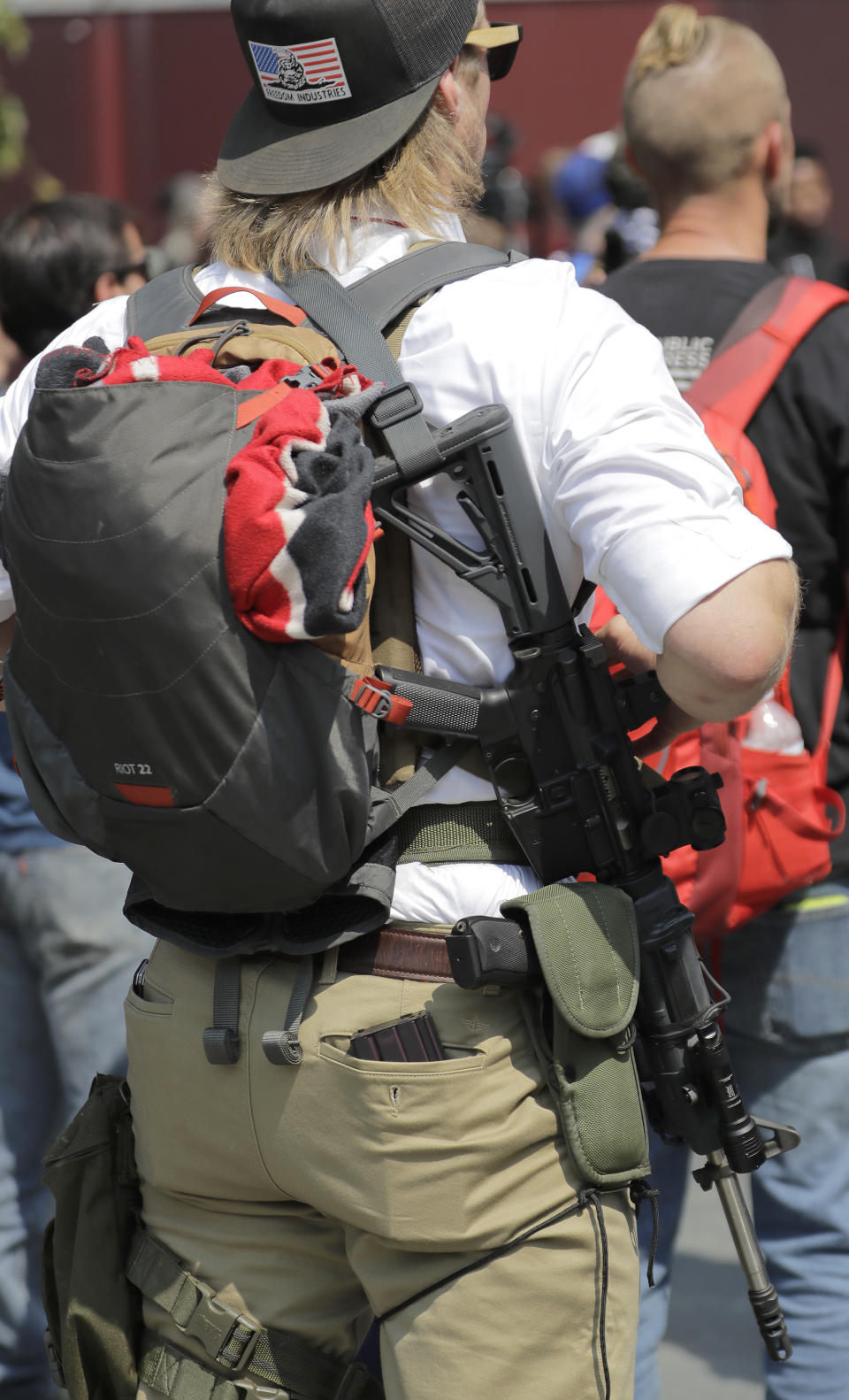 A supporter of a rally held by members of Patriot Prayer and other groups advocating for gun rights wears an AR-15 rifle and a sidearm during the rally, Saturday, Aug. 18, 2018, at City Hall in Seattle. (AP Photo/Ted S. Warren)