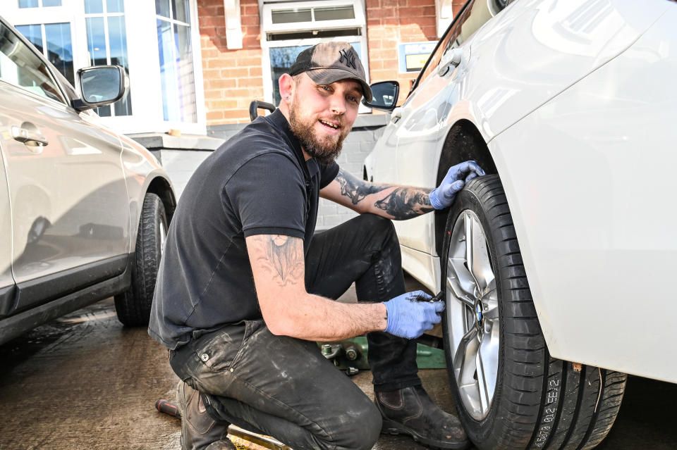 Jake Bow,29, tyre fitter from Hereford Tyres. Photo released February 4 2024.  See SWNS story SWLNpotholes. People living in the pothole capital of England say the roads are so bad itâ€™s like â€œdriving over the moonâ€. A study found Hereford had more potholes than any other area in the country â€“ with 25,000 being reported to the council last year alone. Data reviewed from reports on the FixMyStreet platform found there was one pothole reported for every 127th resident in Hereford. Locals even say the pavements are â€œfalling apartâ€ with some saying they are too scared to venture out after dark in case they trip over.
