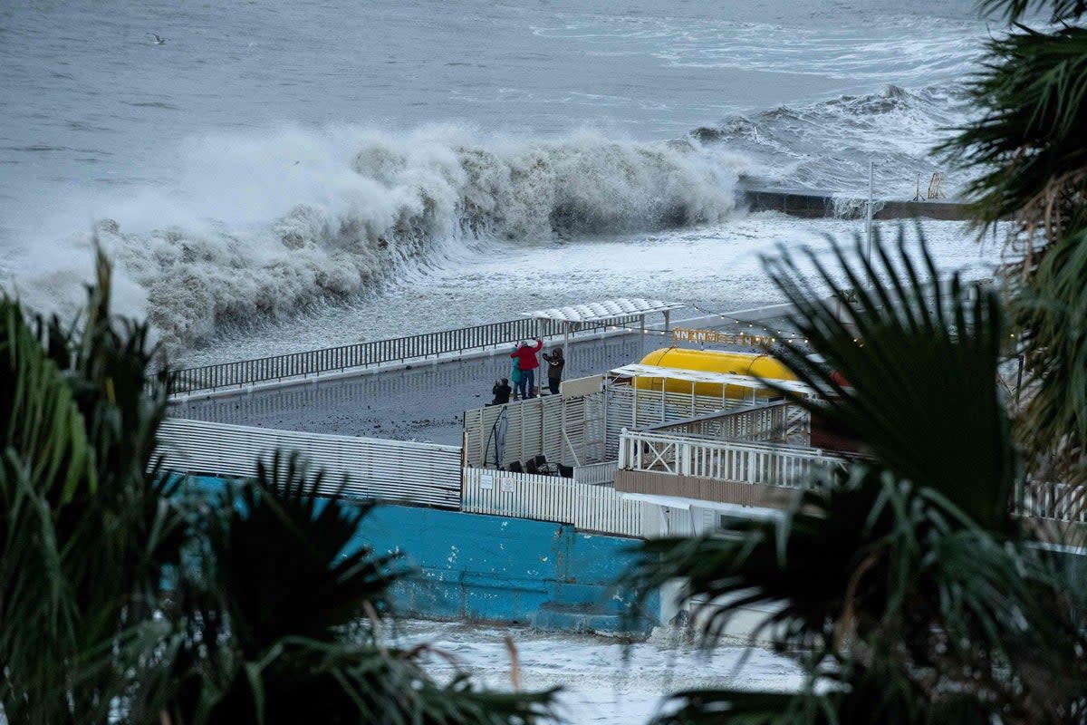 Waves crash against a seafront during a storm in the Black Sea resort city of Sochi (AFP via Getty Images)