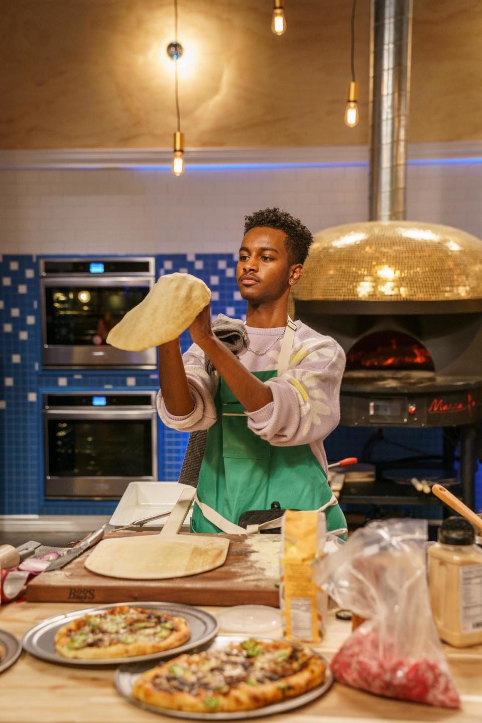 A contestant tosses some pizza dough in Hulu's "Best in Dough."