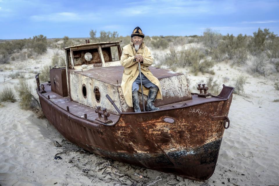 Ali Shadilov, a former fisherman of the Aral Sea, sits on a dilapidated boat in Muynak, Uzbekistan, Tuesday, June 27, 2023. The Associated Press interviewed Shadilov and others in Muynak, Uzbekistan – all residents in their 60s and 70s who’ve long been tied to the sea, or what remains of it. (AP Photo/Ebrahim Noroozi)