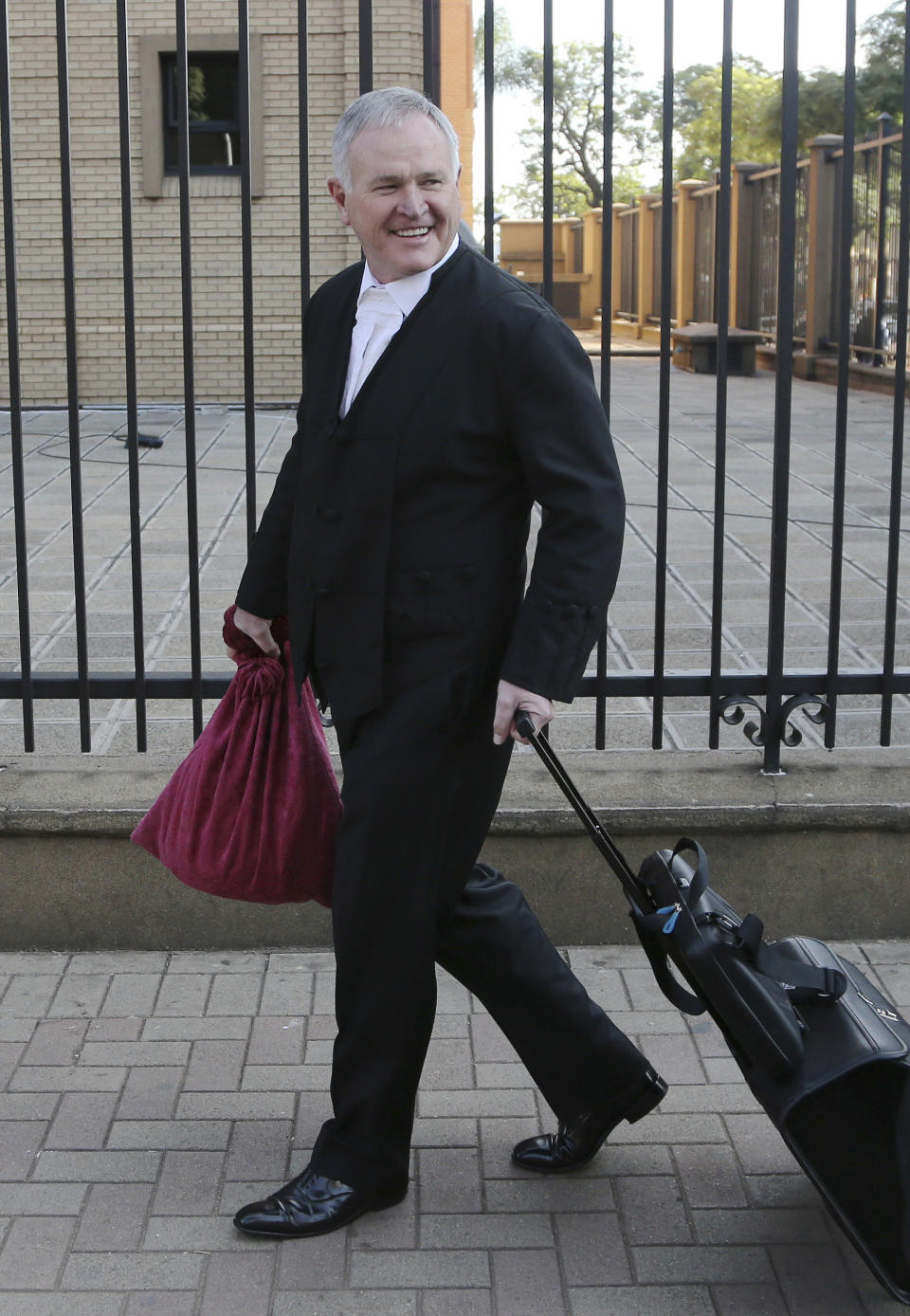 Barry Roux, the lawyer defending Oscar Pistorius, arrives at the high court in Pretoria, South Africa, Tuesday, April 8, 2014. Pistorius, who is charged with murder for the shooting death of his girlfriend, Reeva Steenkamp, on Valentines Day in 2013, was testifying for a second day at his murder trial Tuesday, answering questions from his defense lawyer. (AP Photo/Themba Hadebe)