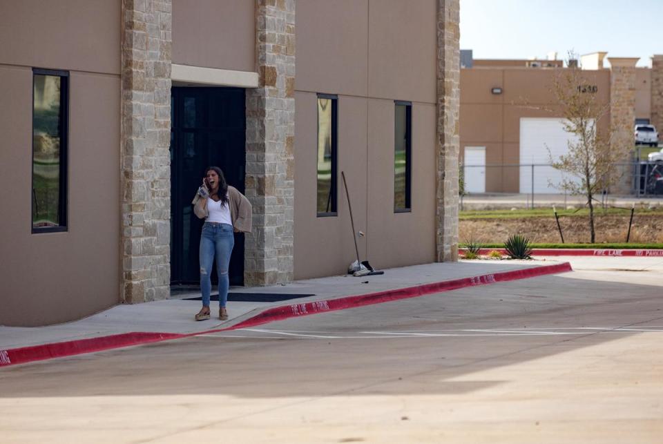 Conservative social media personality Ella Maulding is seen talking on the phone outside of the offices of Pale Horse Strategies in Fort Worth on Oct. 6, 2023.