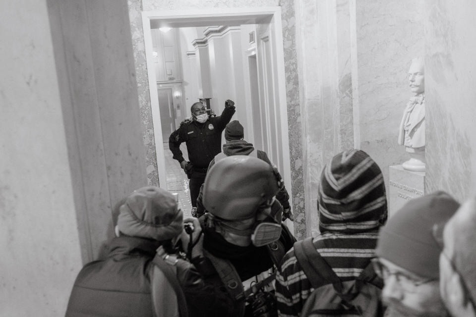 A Capitol Police officer attempts to stop pro-Trump rioters from entering further into the Capitol.<span class="copyright">Christopher Lee for TIME</span>