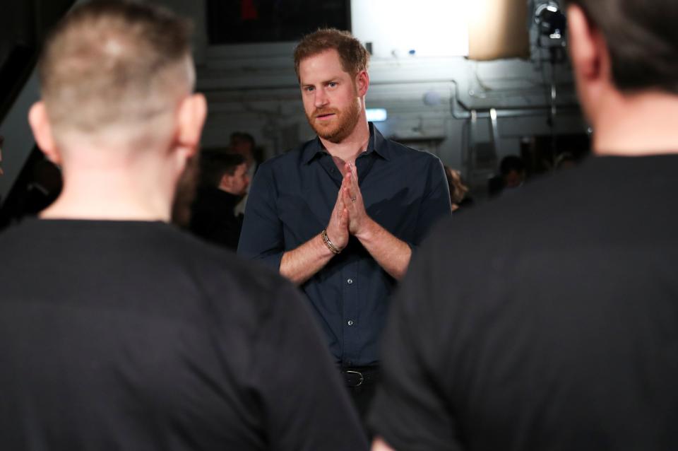 Britain's Prince Harry, Duke of Sussex chats with members of the Invictus Games Choir during his meeting with US singer Jon Bon Jovi at Abbey Road Studios in London on February 28, 2020, where they were to record a special single in aid of the Invictus Games Foundation.