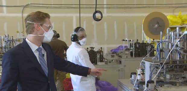 Vitacore president Mikhail Moore, left, at his facility that now manufactures more than six million N95-type masks each month in Burnaby, B.C.