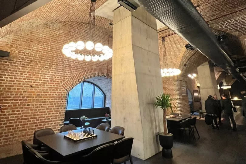 Inside the luxurious Viadux Phase One in Manchester city centre - with the concrete support pillars visible between the Victorian red brick features