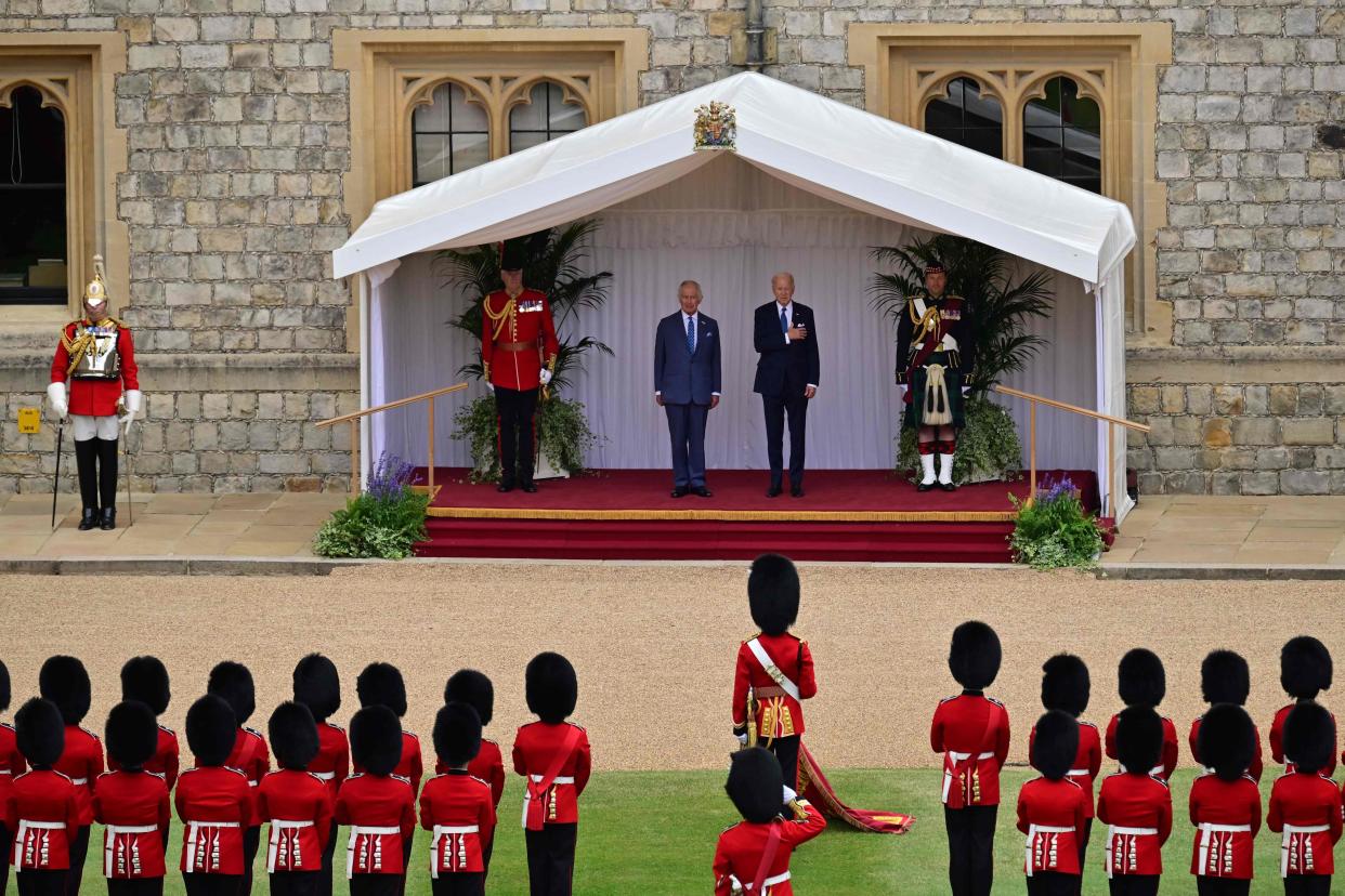 US President Joe Biden and Britain's King Charles III on the dais, listen to the US National Anthem (POOL/AFP via Getty Images)