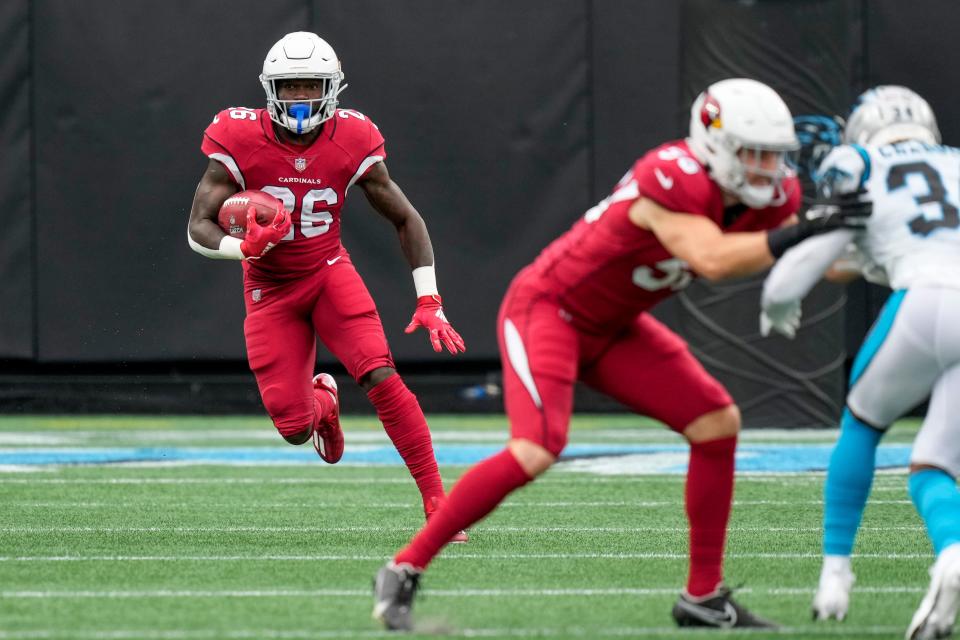 Oct 2, 2022; Charlotte, North Carolina, USA; Arizona Cardinals running back Eno Benjamin (26) runs back a kick-off against the Carolina Panthers during the first quarter at Bank of America Stadium.