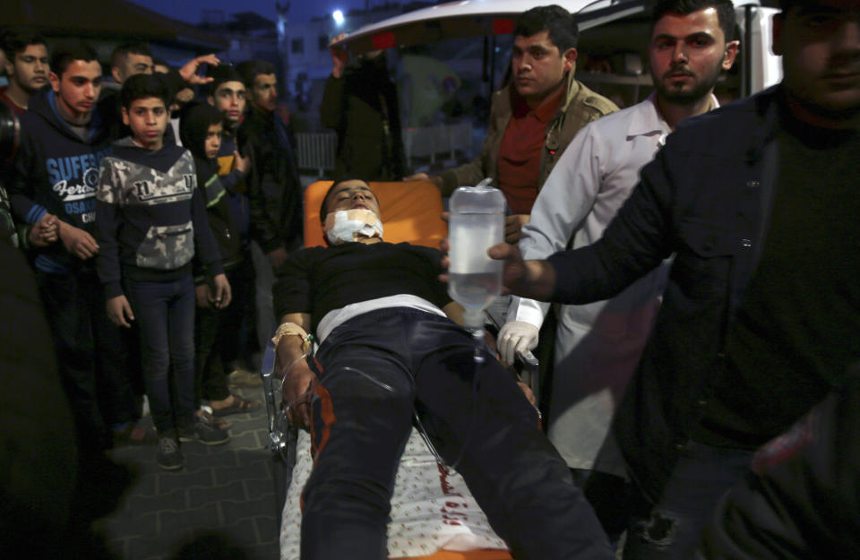 Medics wheel a wounded teenager, who was shot by Israeli troops during a protest at the Gaza Strip's border with Israel, into the treatment room of Shifa hospital in Gaza City, Friday, March 8, 2019. (AP Photo/Adel Hana)