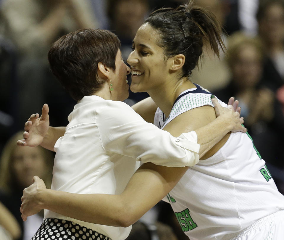 Notre Dame forward Taya Reimer (12) embraces Notre Dame head coach Muffet McGraw during the second half of the semifinal game against Maryland in the Final Four of the NCAA women's college basketball tournament, Sunday, April 6, 2014, in Nashville, Tenn. Notre Dame won 87-61. (AP Photo/Mark Humphrey)