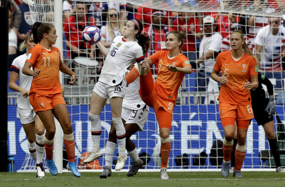 Netherlands' Vivianne Miedema, center right, challenges United States' Rose Lavelle, center left, during the Women's World Cup final soccer match between US and The Netherlands at the Stade de Lyon in Decines, outside Lyon, France, Sunday, July 7, 2019. (AP Photo/Alessandra Tarantino)