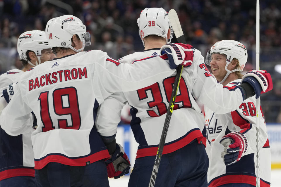 Washington Capitals center Nicklas Backstrom (19) celebrates with teammates after scoring against the New York Islanders during the third period of an NHL hockey game Saturday, March 11, 2023, in Elmont, N.Y. (AP Photo/Mary Altaffer)