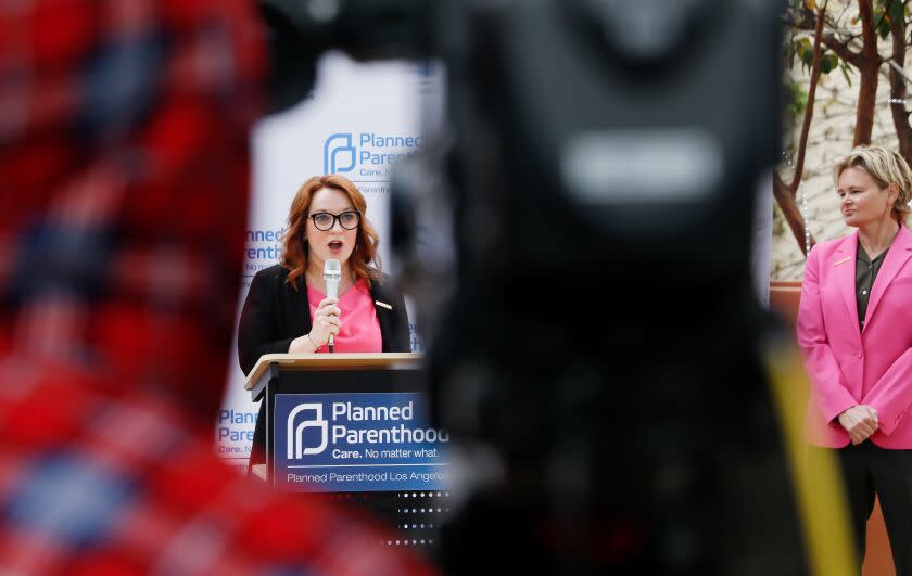 LOS ANGELES-CA-APRIL 10, 2023: President & Chief Executive Officer of Planed Parenthood Los Angeles Sue Dunlap, right, listens as Los Angeles County Supervisor Lindsey Horvath speaks at a news conference to respond to the Food and Drug Administration's decision to rescind the federal approval for Mifepristone, a drug that blocks a hormone called progesterone that is needed for a pregnancy to continue, in Los Angeles on April 10, 2023. (Christina House / Los Angeles Times)