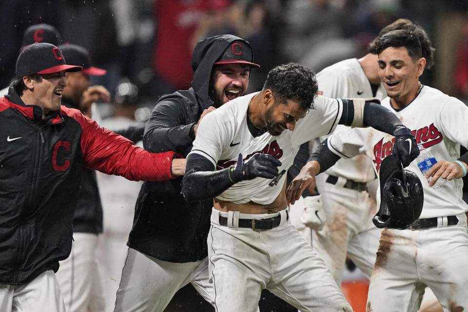 Cleveland Indians' Oscar Mercado, center, is mobbed by teammates after hitting a two-run home run in the seventh inning in the second baseball game of a doubleheader against the Chicago White Sox, Thursday, Sept. 23, 2021, in Cleveland. (AP Photo/Tony Dejak)