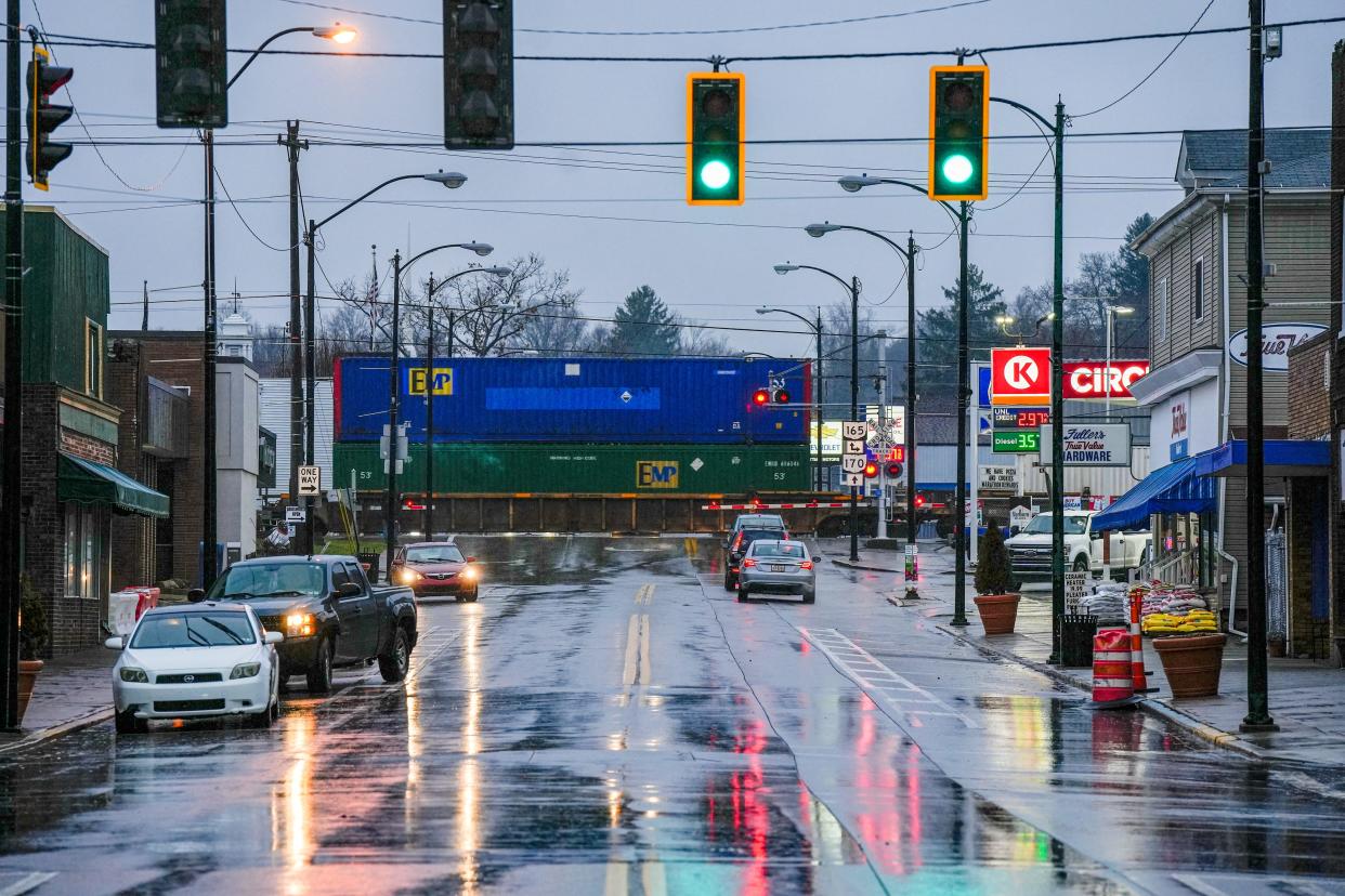 A Norfolk Southern train passes Market Street in downtown East Palestine on Wednesday, January 24, 2024, almost a year after a train derailed near Market Street when a mechanical issue with a rail car axle caused a fiery accident. Fifty cars derailed and 11 were carrying hazardous materials.